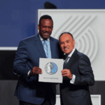 NBA legend Rolando Blackman (left) and NBA deputy commissionee Mark Tatum (right) hold the Dallas mavericks' card after the team won the No.1 pick in the 2025 NBA Draft lottery on Monday. Cooper Flag to Texas after Mavs win NBA draft lottery
