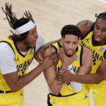 Indiana Pacers guard Tyrese Haliburton (middle) shows the "choke" sign on his neck in celebration in Game 1 of the Pacers vs Knicks series on Wednesday in New York. Knicks vs Pacers series has Indiana drawing first blood in OT