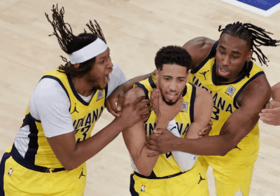 Indiana Pacers guard Tyrese Haliburton (middle) shows the "choke" sign on his neck in celebration in Game 1 of the Pacers vs Knicks series on Wednesday in New York. Knicks vs Pacers series has Indiana drawing first blood in OT