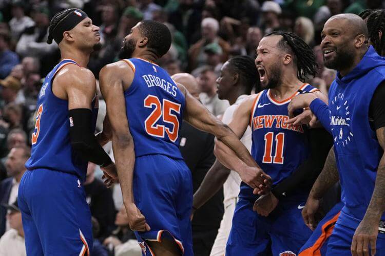 New York guard/forward Mikal Bridges (25, middle) bodies teammate Josh Hart (left), while Jalen Brunson (11, right) roars in approval after Game 1 of their first-round series against the Boston Celtics on Monday. Celtics vs Knicks sees Bridges' steal seals it for New York in OT