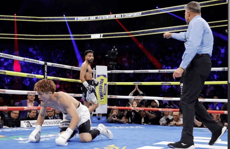 American Ramon Cardenas (middle) stands in one corner after he knocked down Japan's Naoya Inoue (left) in the second round of their bout in Las Vegas on Sunday night. Inoue survives knockdown to stop Cardenas in Las Vegas return