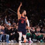 New York guard Jalen Brunson raises his fingers signalling a 3-pointer against the Boston Celtics in Game 4 of their first-round series on Monday. Knicks vs Celtics shows New York get 3-1 lead; Tatum injured