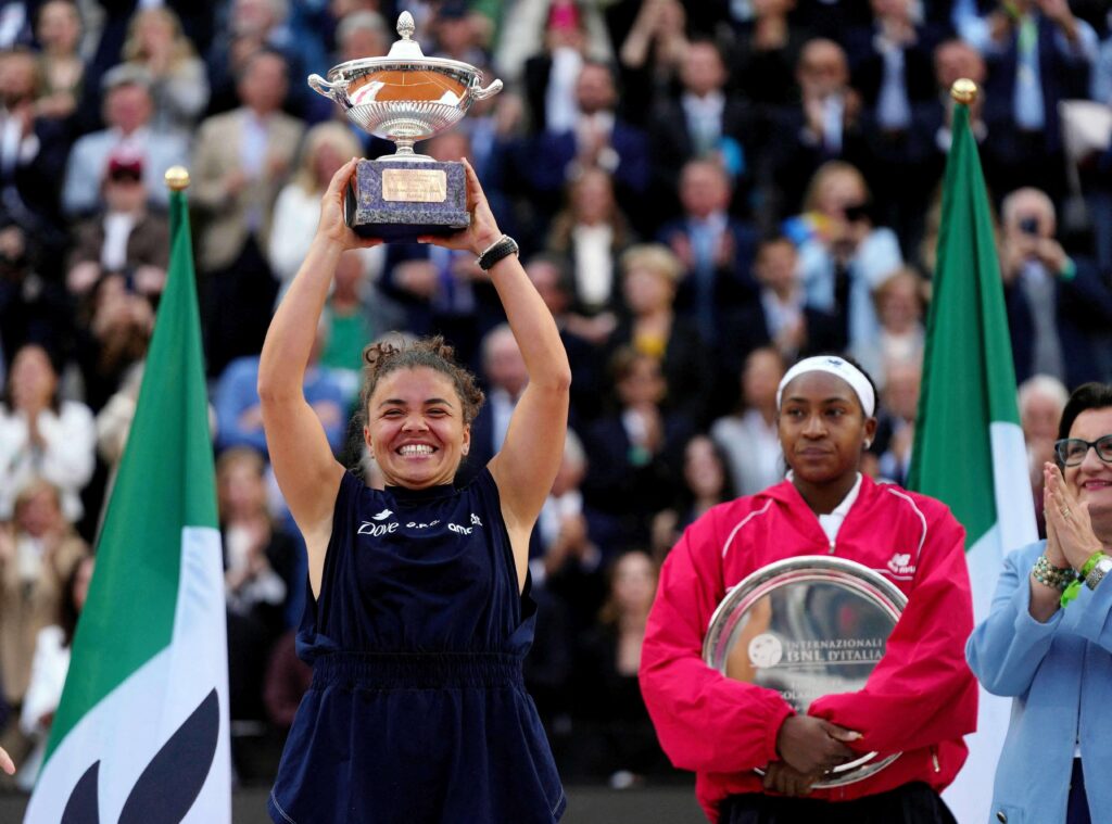 Italy's Jasmine Paolini (left) hoists her trophy while American COco Gauff (right) looks on after their women's singles final on Saturday. Paolini to move up to No.4 in WTA rankings after Italian Open win