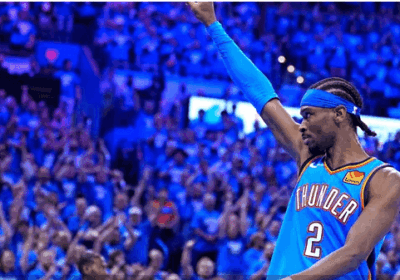 OKC guard Shai Gilgeous Alexander raises his right arm to acknowledge the crowd after taking a shot in Game 7 of their Western Conference semifinals vs the Denver Nuggets on Sunday. Nuggets vs Thunder sees OKC in West finals against Wolves