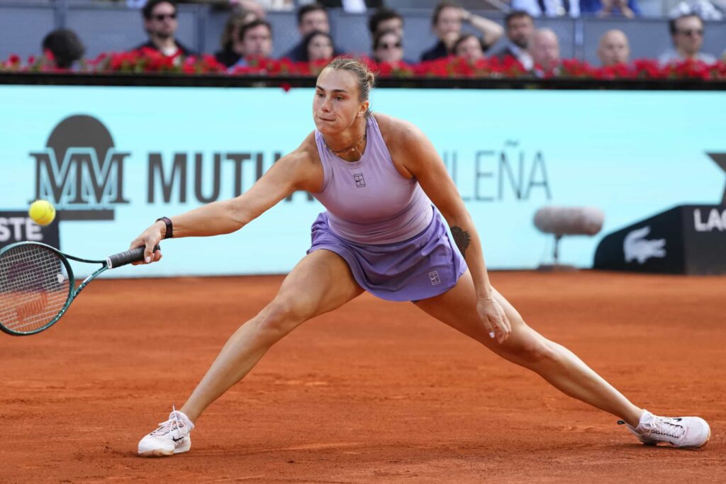 Belarus' Aryna Sabalenka slides for a shot at her Madrid Open final against American Coco Gauff on Saturday. Ruud returns to top 10 after Madrid Open victory; Sabalenka wins
