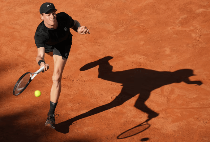 Italian Jannik Sinner slides to take a shot against Jesper de Jong at the Italian Open on Monday. Sinner resumes surge at Italian Open; Gauff takes down Raducanu