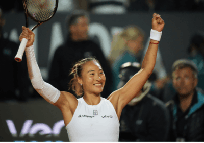 China's Qinwen Zheng raises her arms in celebrationafter her match against Aryna Sabalenka in Rome on Wednesday. Zheng stuns Sabalenka in Italian Open; Alcaraz reaches semis