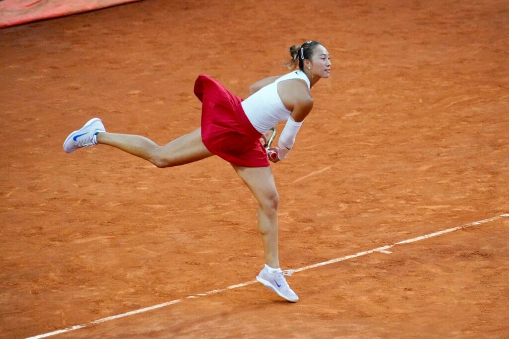 China's Qinwen Zheng stretches to return a shot against Aryna Sabalenka in Rome on Wednesday. Zheng stuns Sabalenka in Italian Open; Alcaraz reaches semis