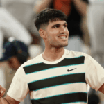 Spain's Carlos Alcaraz smiles for the crowd in his French Open quarterfinal vs American Tommy Paul on Tuesday. Alcaraz reaches French Open semis; Swiatek, Sabalenka in last 4