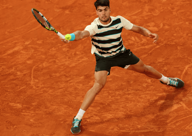 Spain's Carlos Alcaraz stretches for a shot in his French Open quarterfinal vs American Tommy Paul on Tuesday. Alcaraz reaches French Open semis; Swiatek, Sabalenka in last 4