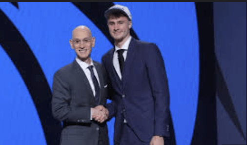 Duke forward Cooper Flagg (right) sahkes hands and poses for photographers with NBA Commissioner Adam Silver (left) after Flagg was picked No.1 overall by the Dallas Mavericks at the 2025 NBA Draft on Wednesday. 2025 NBA Draft sees Flagg go No.1 at Dallas; Harper to Spurs