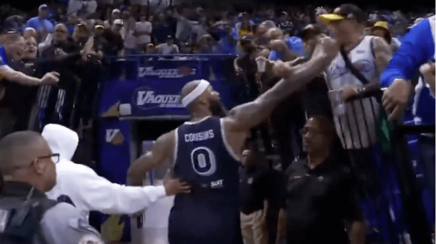 Former NBA star DeMarcus Cousins (0, middle) interacts with a fan while exiting the court before the fan threw a drink at him that nearly led to a brawl on Monday night. Ex-NBA star Cousins goes viral, loses temper in Puerto Rico game
