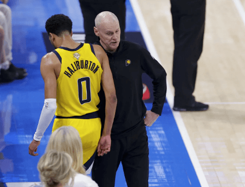 Indiana guard Tyrese Haiburton (o, left) limps back on the bench as coach Rick Carlisle (right) comforts him) in Game 5 of the NBA Finals on Tuesday. NBA Finals Game 6 sees OKC seek title; can Haliburton return?