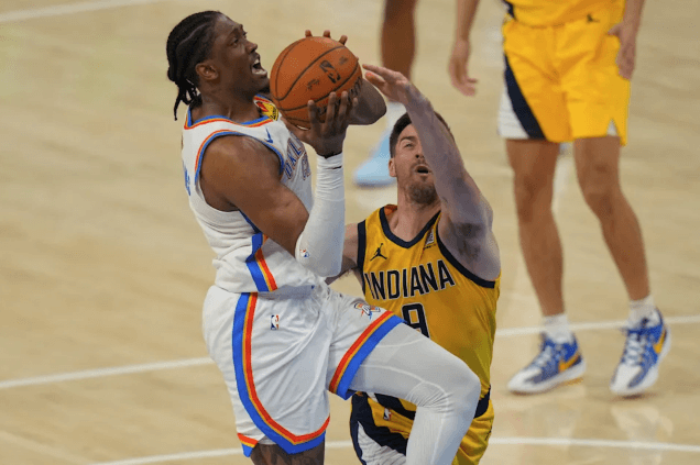 OKC forward Jalen Williams (left) drives against Indiana guard TJ McConnell (right) in Game 5 of the NBA Finals on Tuesday. NBA Finals Game 6 sees OKC seek title; can Haliburton return?